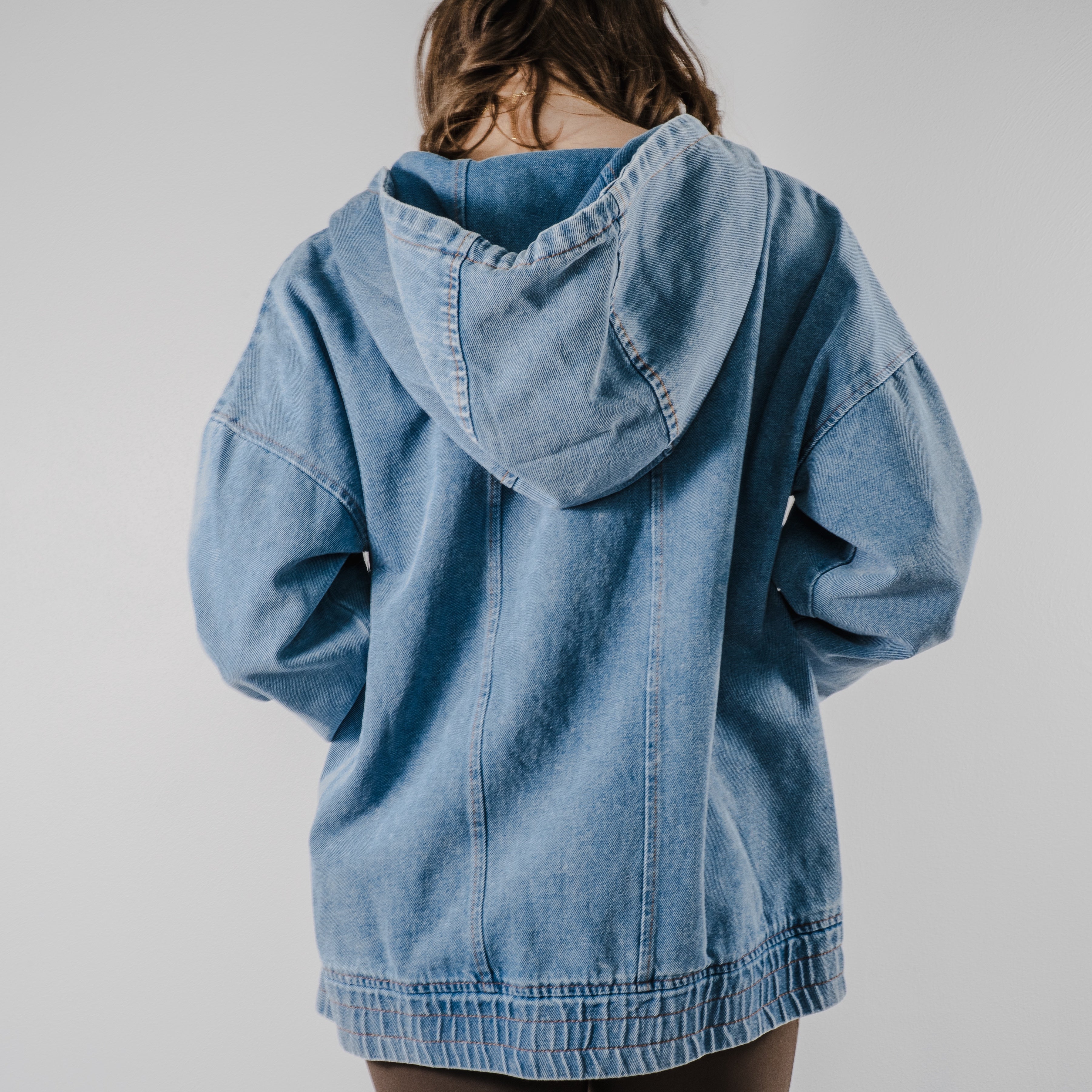 Back view of the model showing the hood of the "Denim Daze Hoodie".