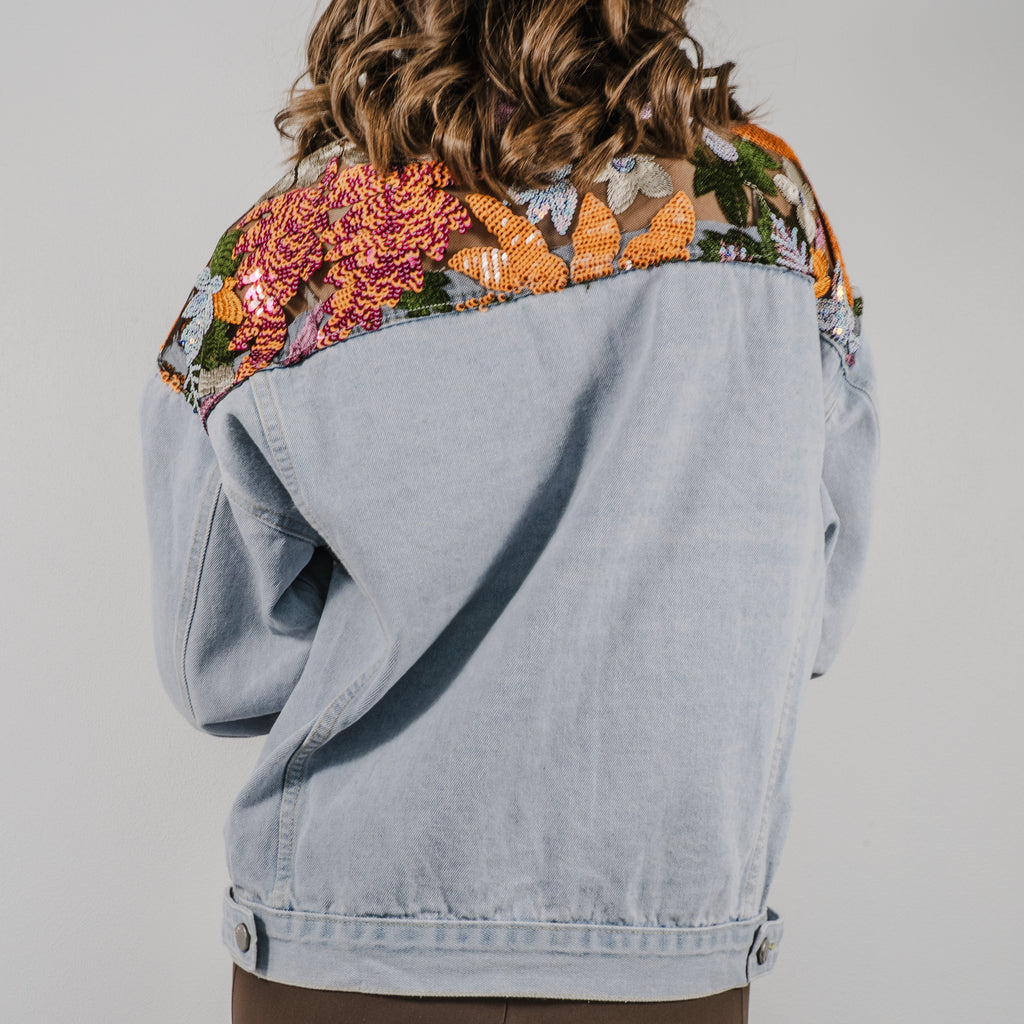 The back view of the Set Free denim jacket showing a large, detailed sequin design across the shoulders.