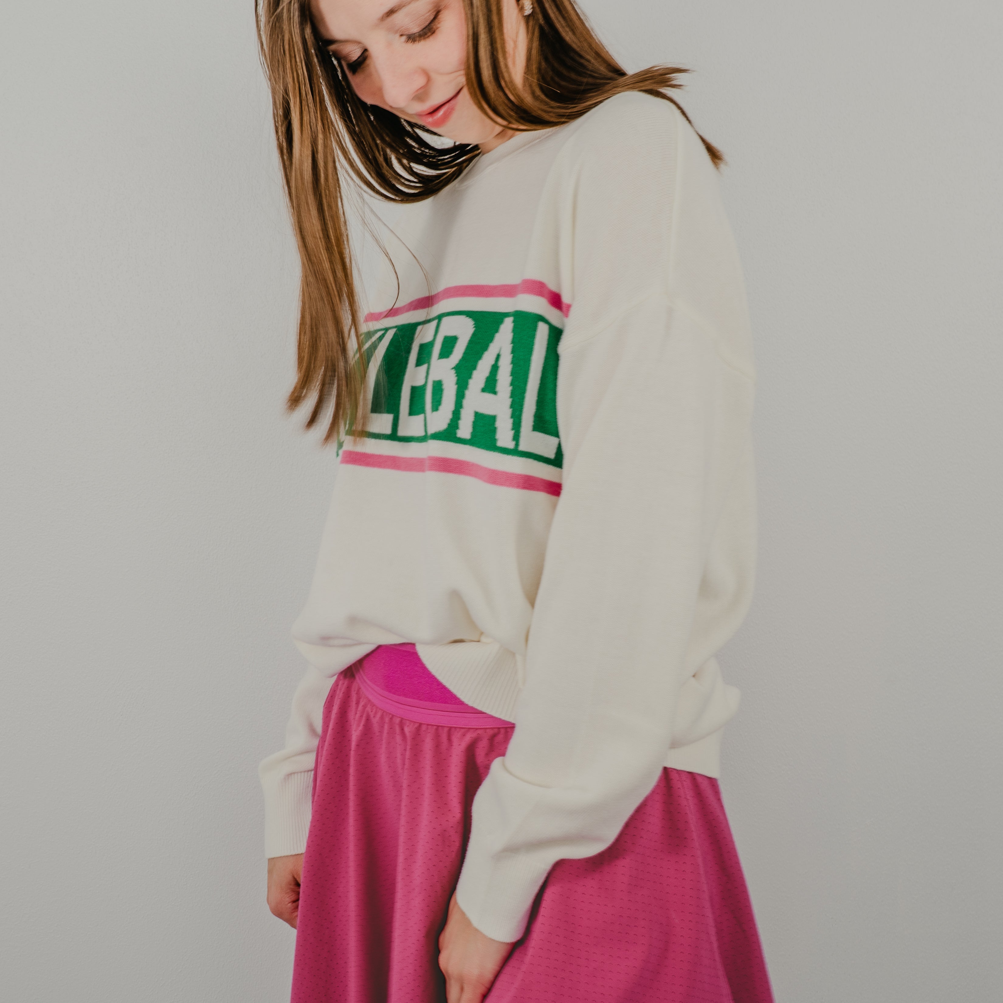 Side view of model wearing the Pickleball Club sweater paired with athletic shorts for a sporty, casual look."