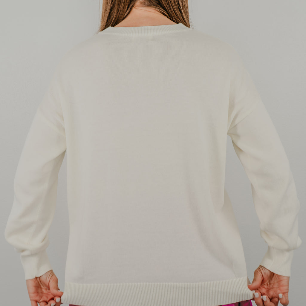 Back view of the sweater to show detail of the soft, ribbed knit cuffs and solid color on the Pickleball Club crewneck sweater.
