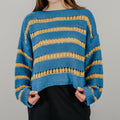 Bold blue and gold striped knit sweater with an oversized boxy silhouette and dropped shoulders.