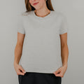 Front view of a light heathered grey short-sleeve 'Basic Bra Tee' featuring a built-in shelf bra and a flattering, form-fitting silhouette.
