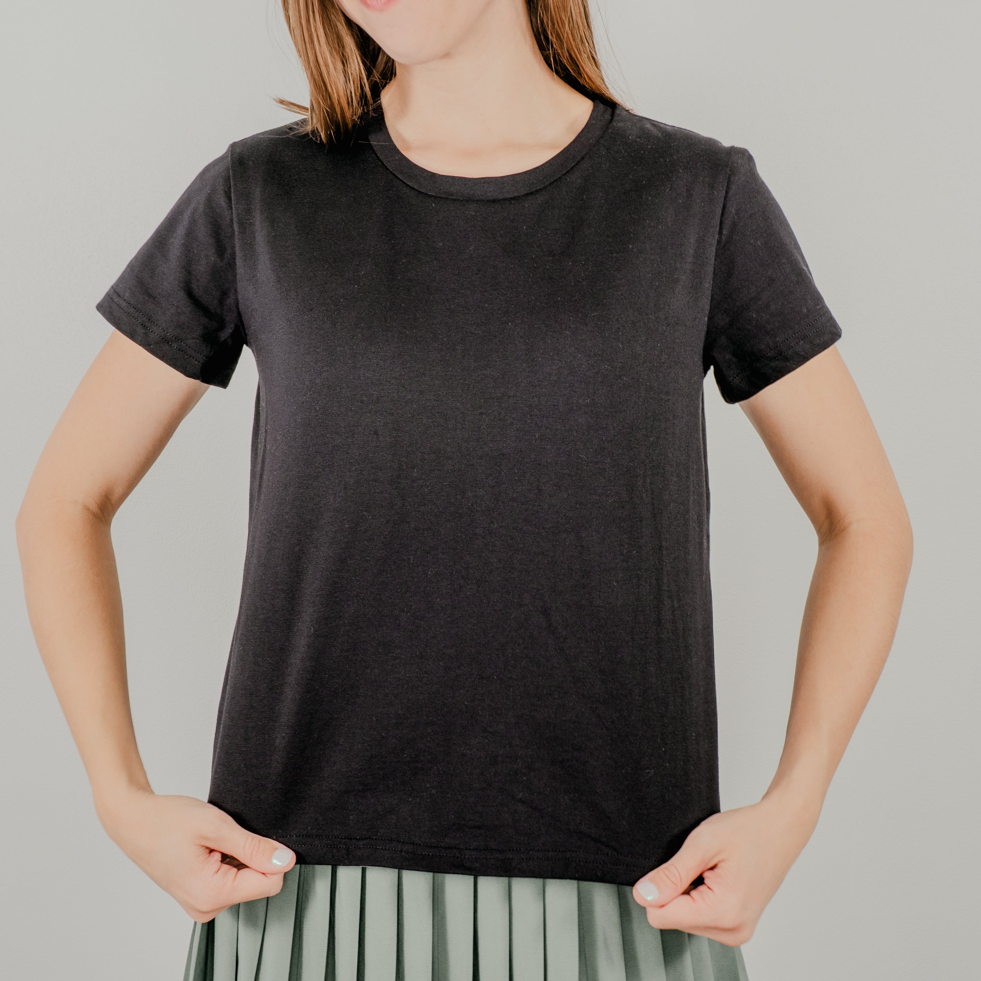 Front view of a black short-sleeve 'Basic Bra Tee' featuring a built-in shelf bra and a flattering, form-fitting silhouette.