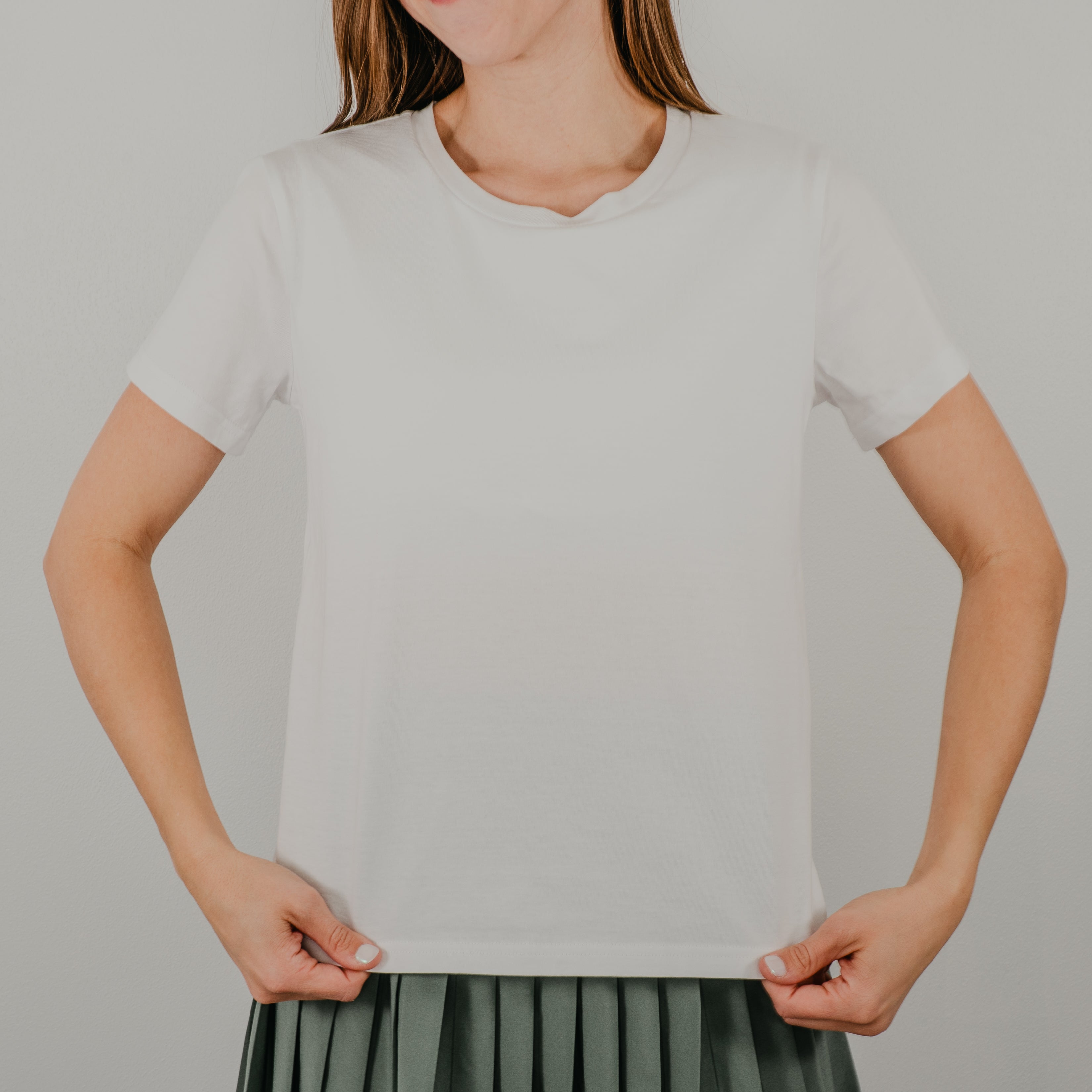 Front view of a white short-sleeve 'Basic Bra Tee' featuring a built-in shelf bra and a flattering, form-fitting silhouette.