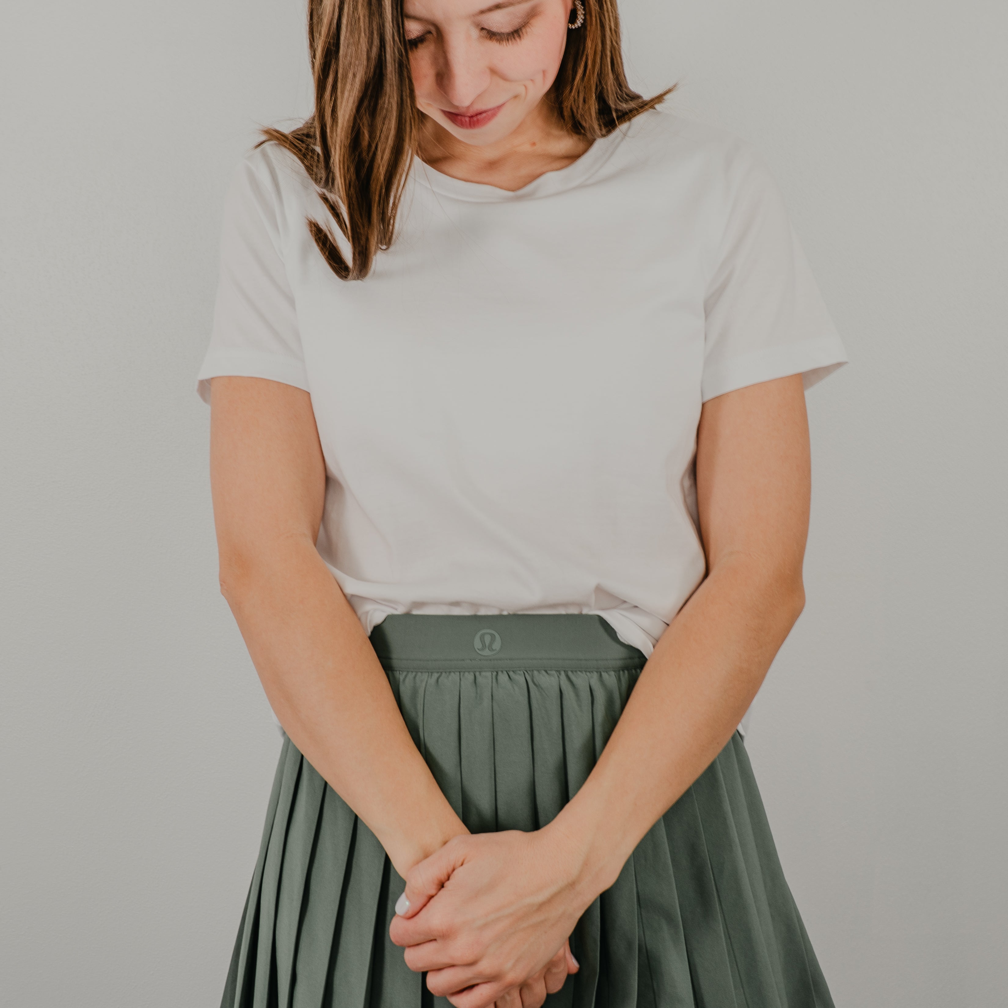 Front view of a white grey short-sleeve 'Basic Bra Tee' featuring a built-in shelf bra and a flattering, form-fitting silhouette.