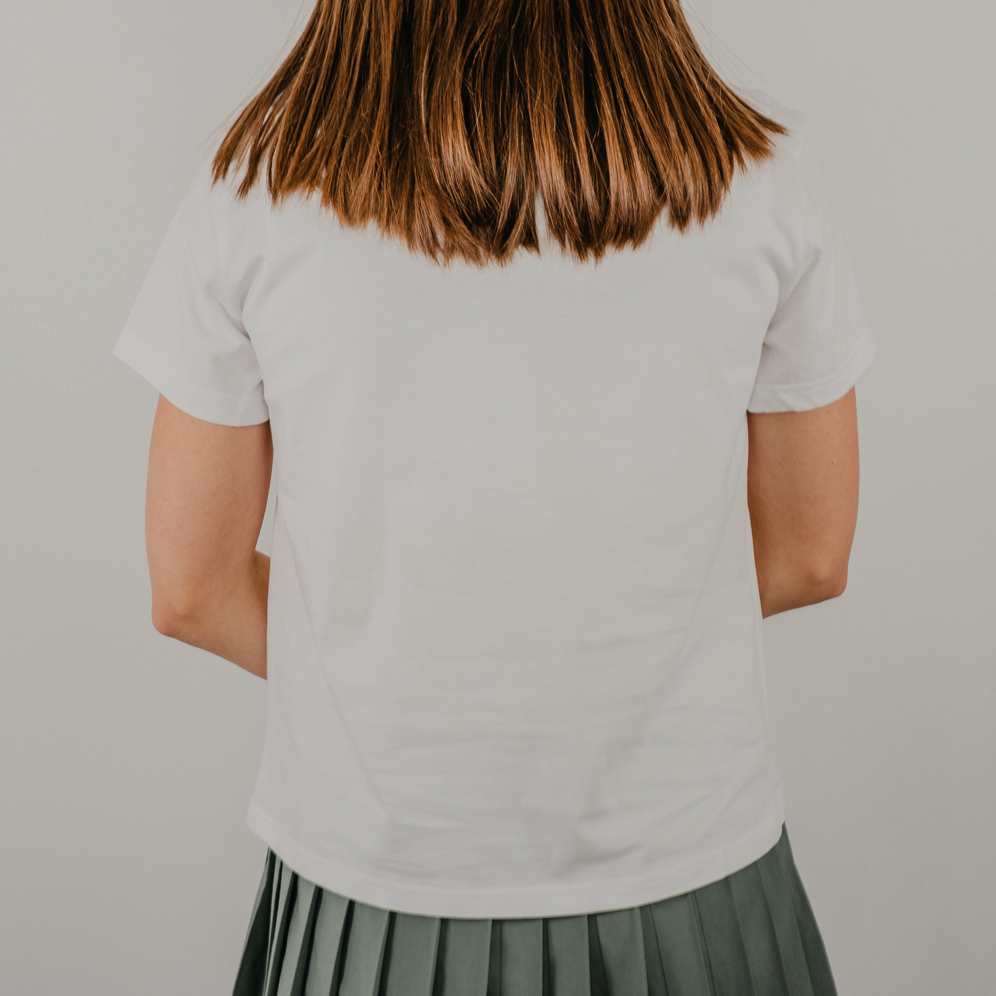 Back view of the white Basic Bra Tee showing the clean, seamless design and comfortable crew neckline.