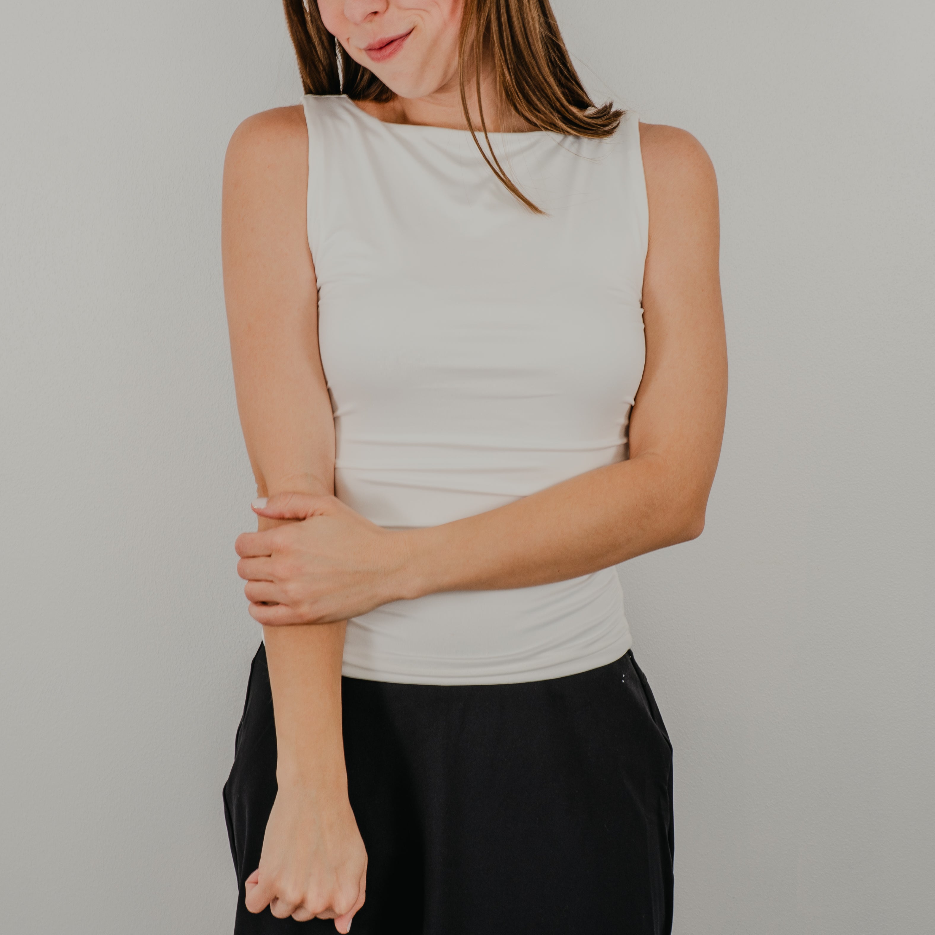 Front view of the Second Skin Tank in a true white, featuring a high scoop neckline and a seamless, form-fitting silhouette.