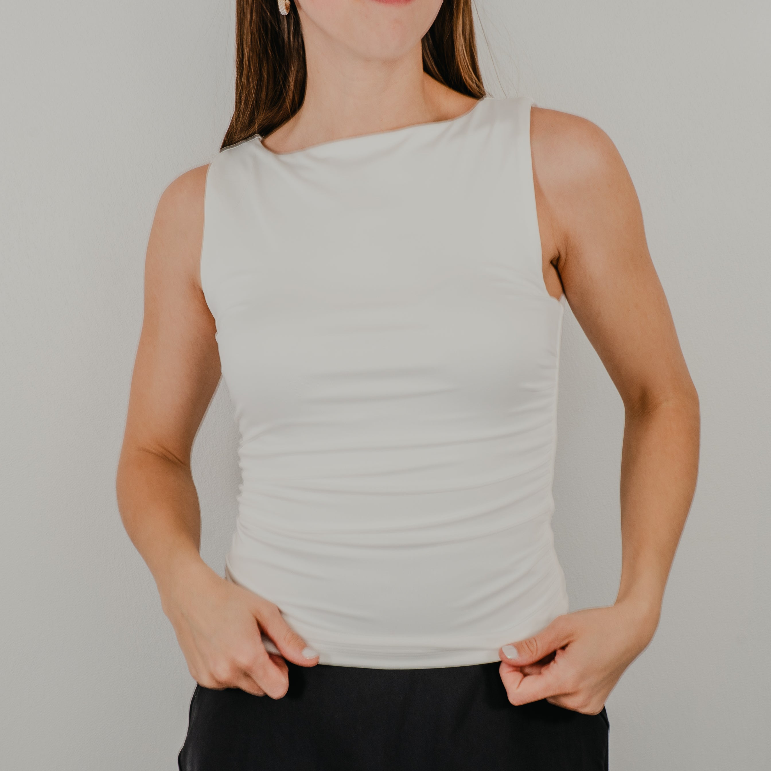 Front view of the Second Skin Tank in a true white, featuring a high neckline and a seamless, form-fitting silhouette.