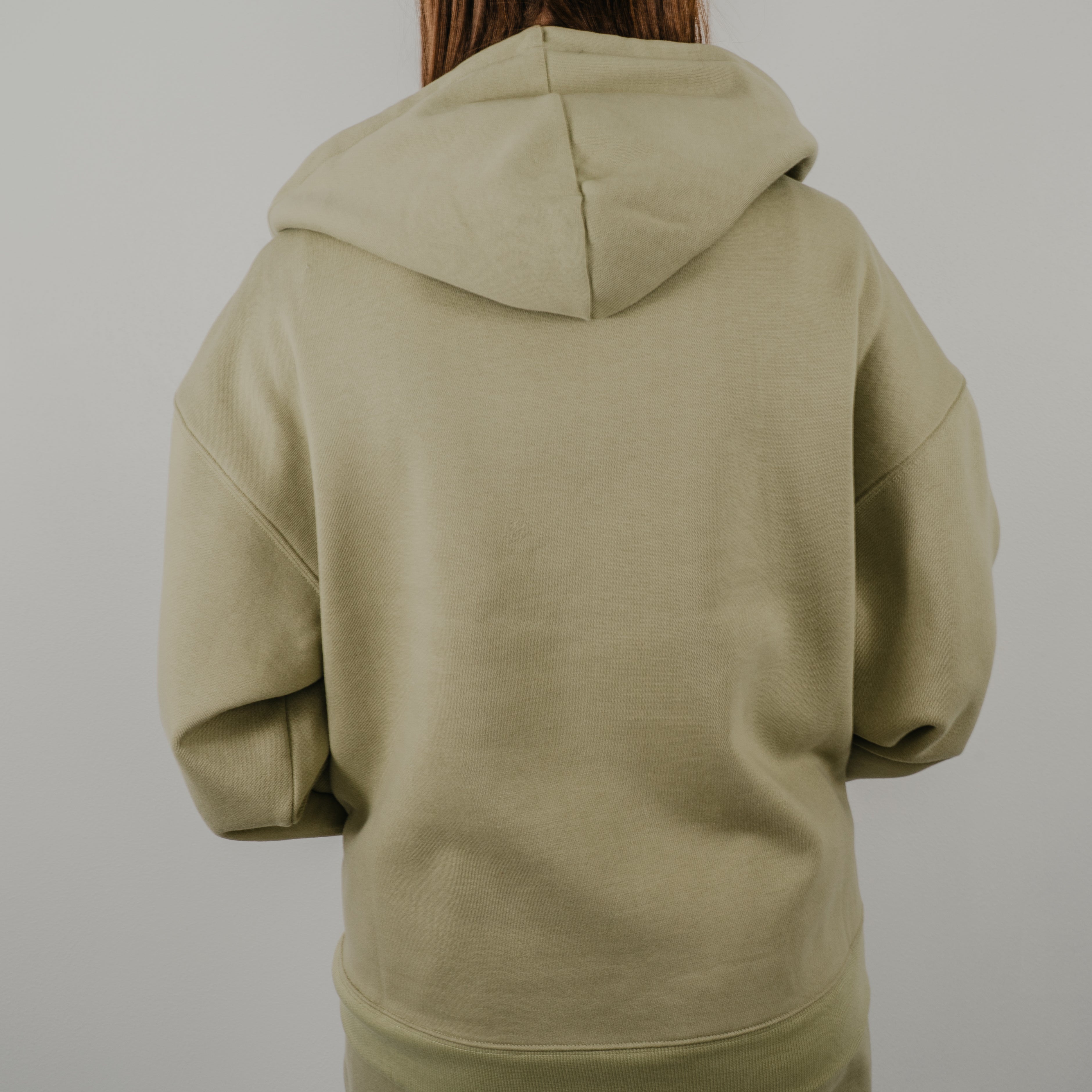 Rear view of the Jet Set Zip Up Hoodie showing the relaxed, slouchy fit and large structured hood.