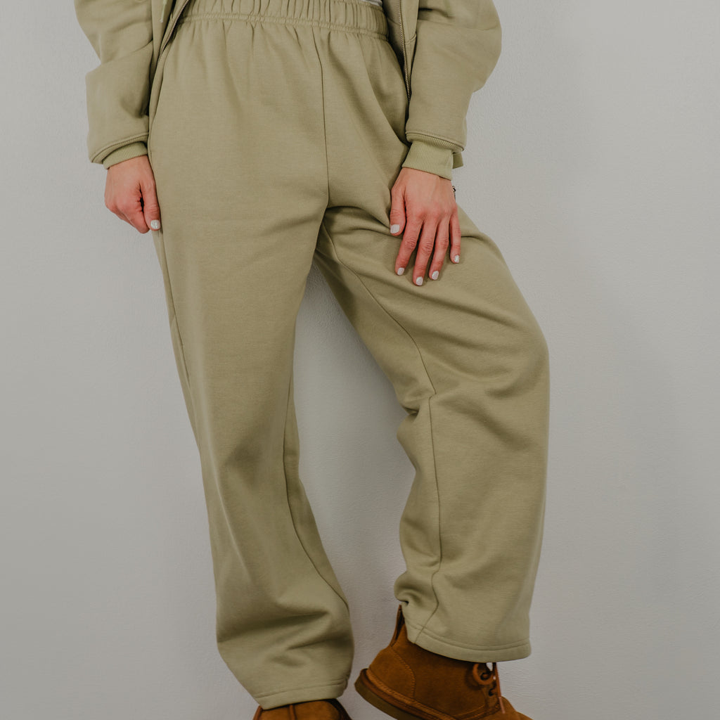 Front view of the high-waisted straight-leg sweatpants with a wide elastic waistband and hidden side pockets.