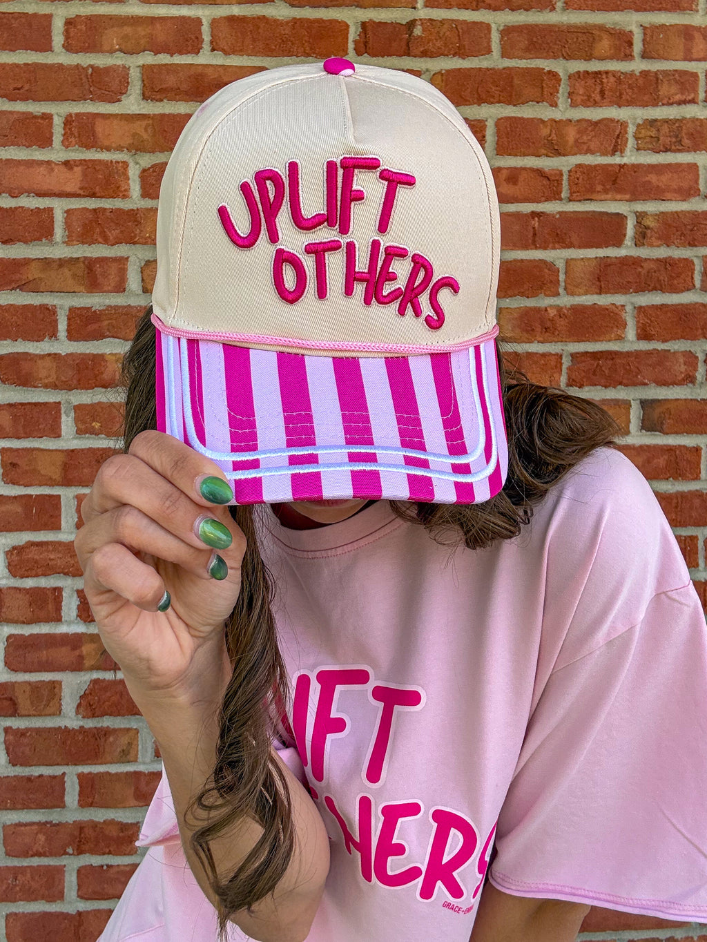 person wearing uplift others hat 